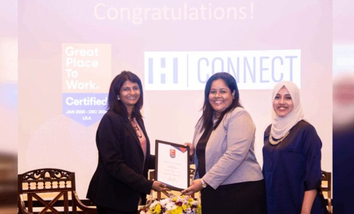 Three women holding "Great Place" certificate.