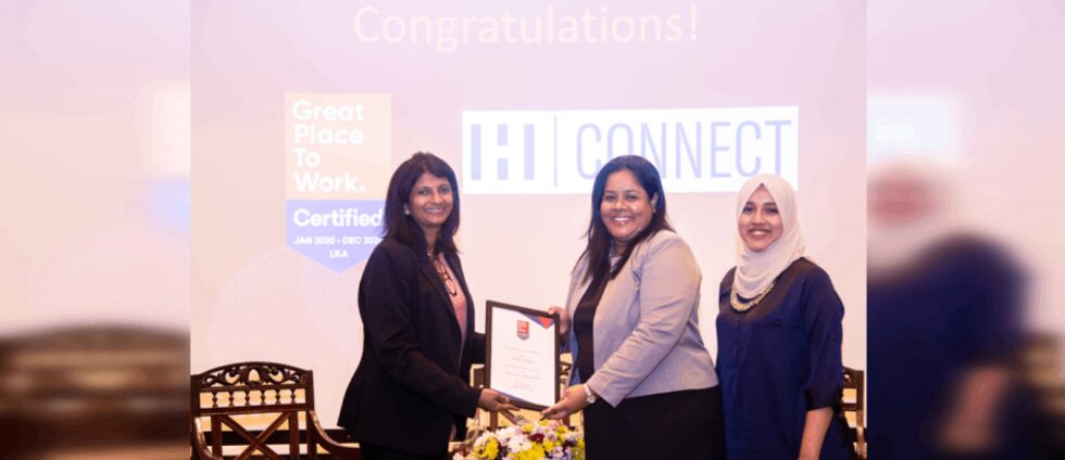Three women holding "Great Place" certificate.