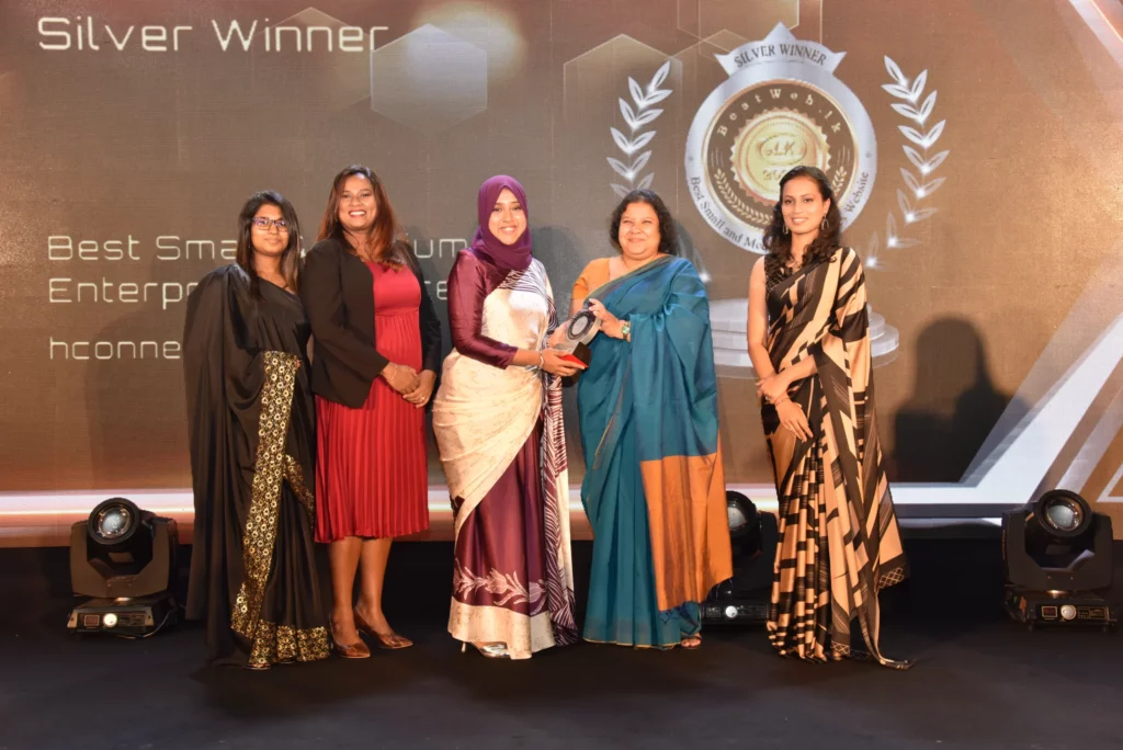 Five women with awards on stage.