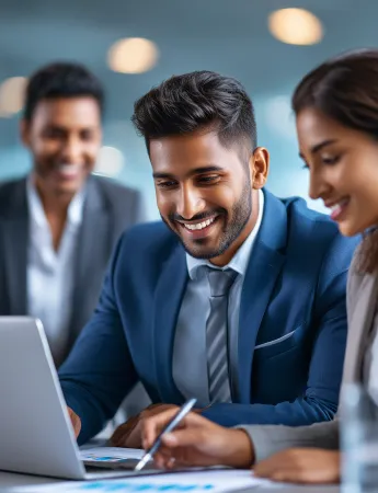Business professionals collaborating, smiling, working on laptop.
