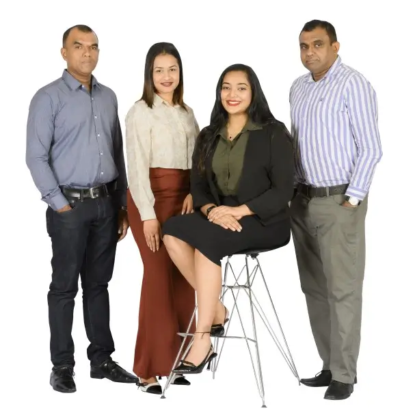 Four professionals posing on white background.